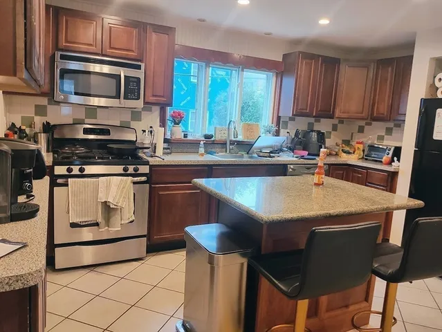 a kitchen with a stove a sink and a microwave