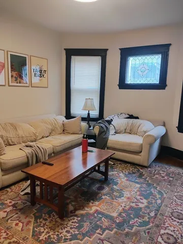 a living room with furniture and a rug