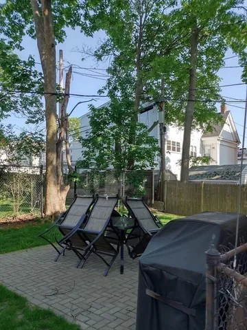 a view of a patio with table and chairs with wooden fence and floor