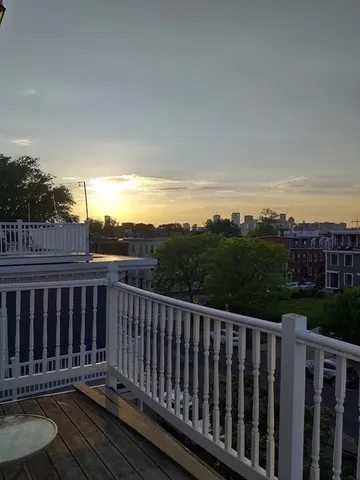 a balcony with wooden floor and fence
