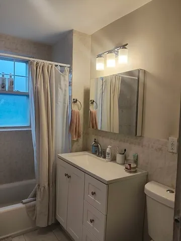 a bathroom with a double vanity sink and mirror