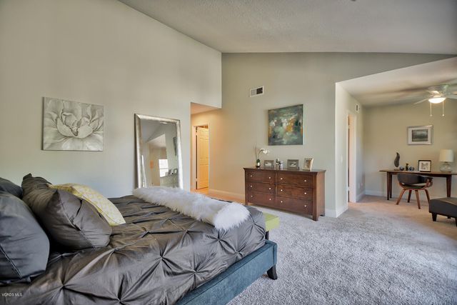 a bedroom with a bed and a table in it