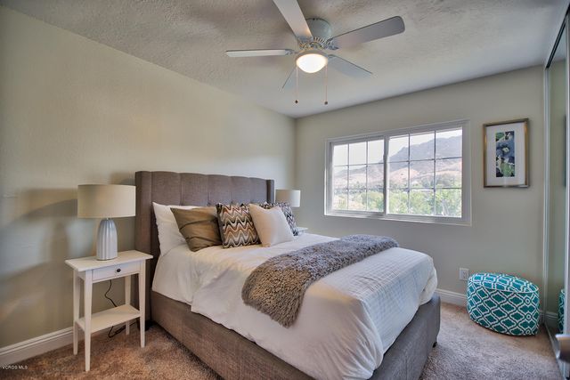 a bedroom with a bed and a chair