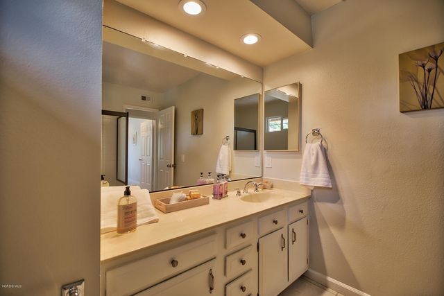 a bathroom with a double vanity sink and mirror