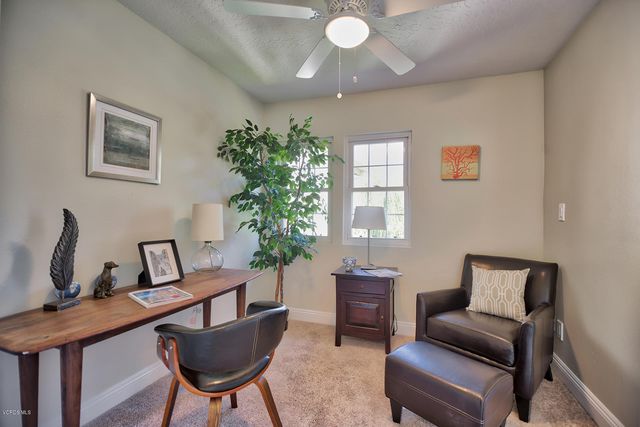 a view of a livingroom with furniture and a potted plant