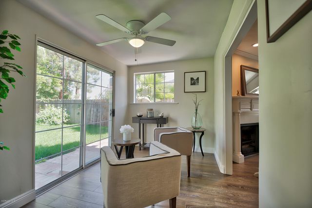 a living room with furniture and a floor to ceiling window