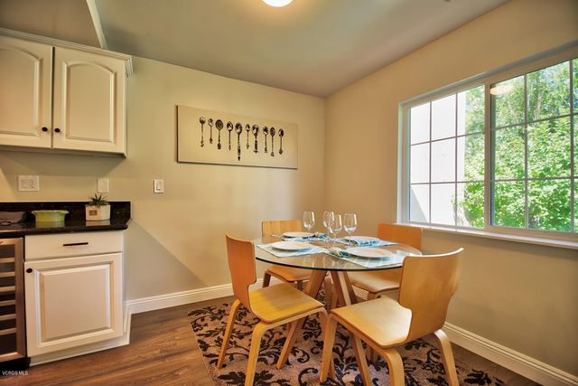 a dining room with furniture a window and wooden floor