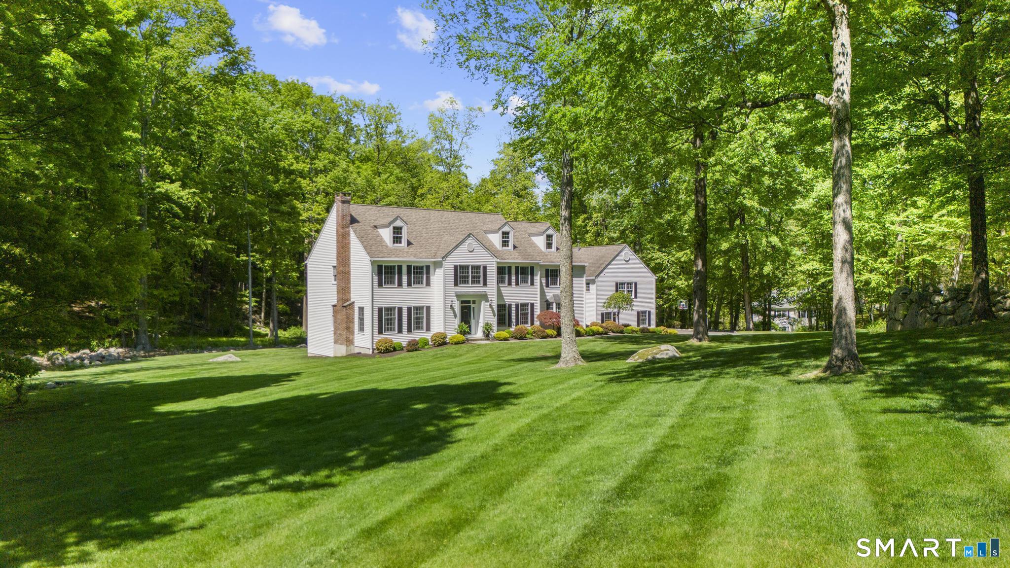 181 Old Branchville Road Ridgefield, CT 06877 - Photo 3 of 40 a view of a white house in front of a big yard with large trees