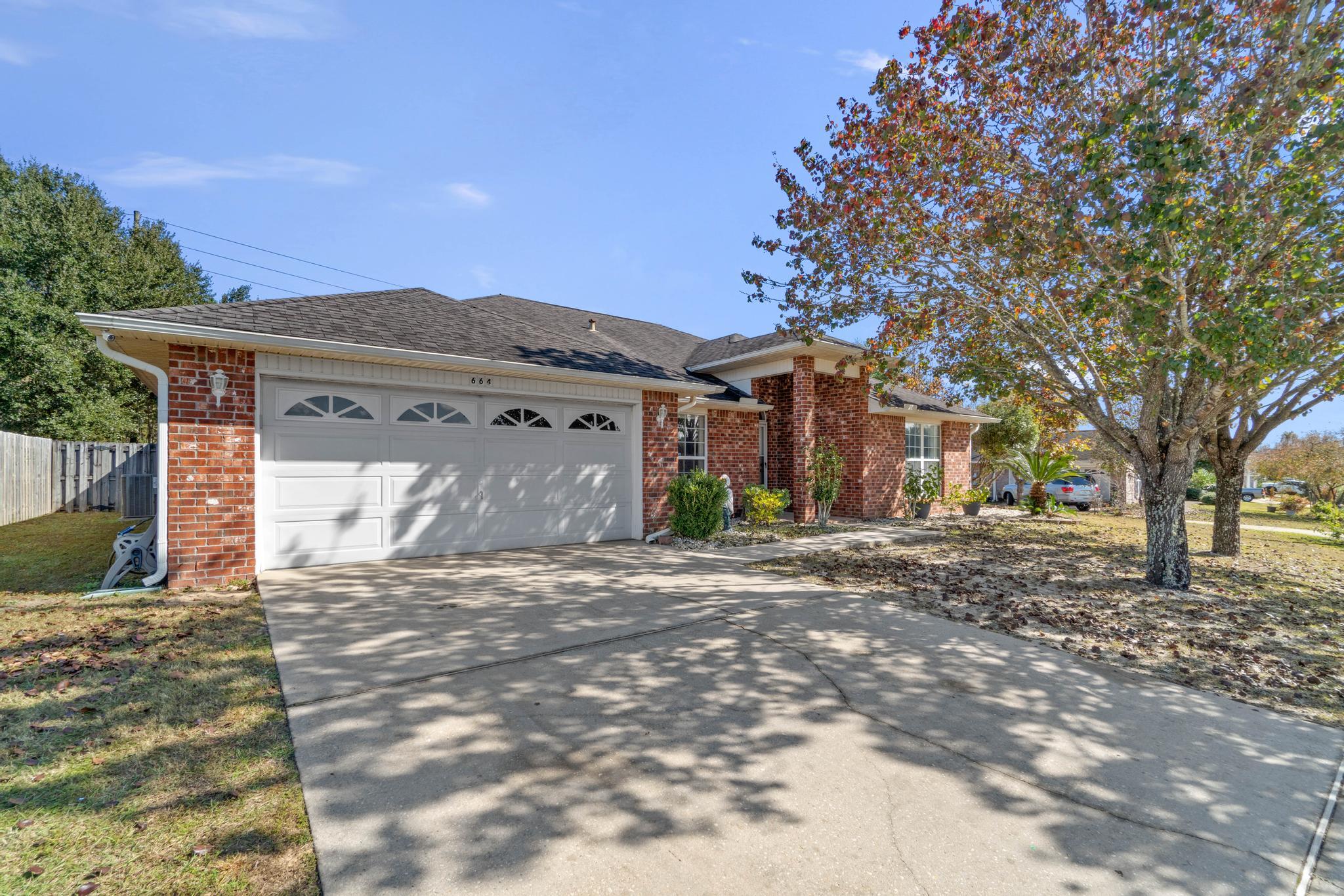 664 Brunson Street Crestview, FL 32536 - Photo 2 of 49 a view of a house with a snow in the yard