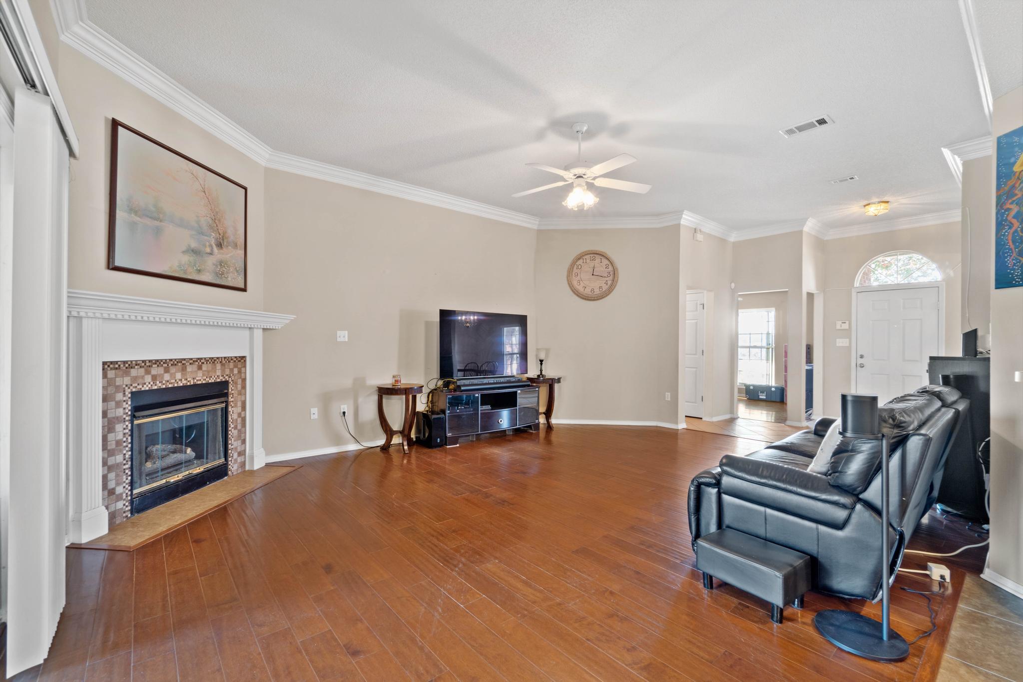 664 Brunson Street Crestview, FL 32536 - Photo 13 of 49 a living room with furniture and a fireplace