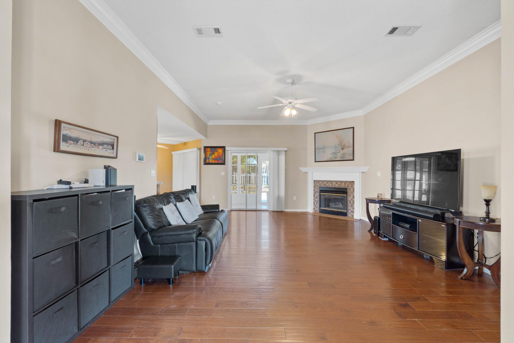 664 Brunson Street Crestview, FL 32536 - Photo 14 of 49 a living room with furniture flat screen tv and fireplace