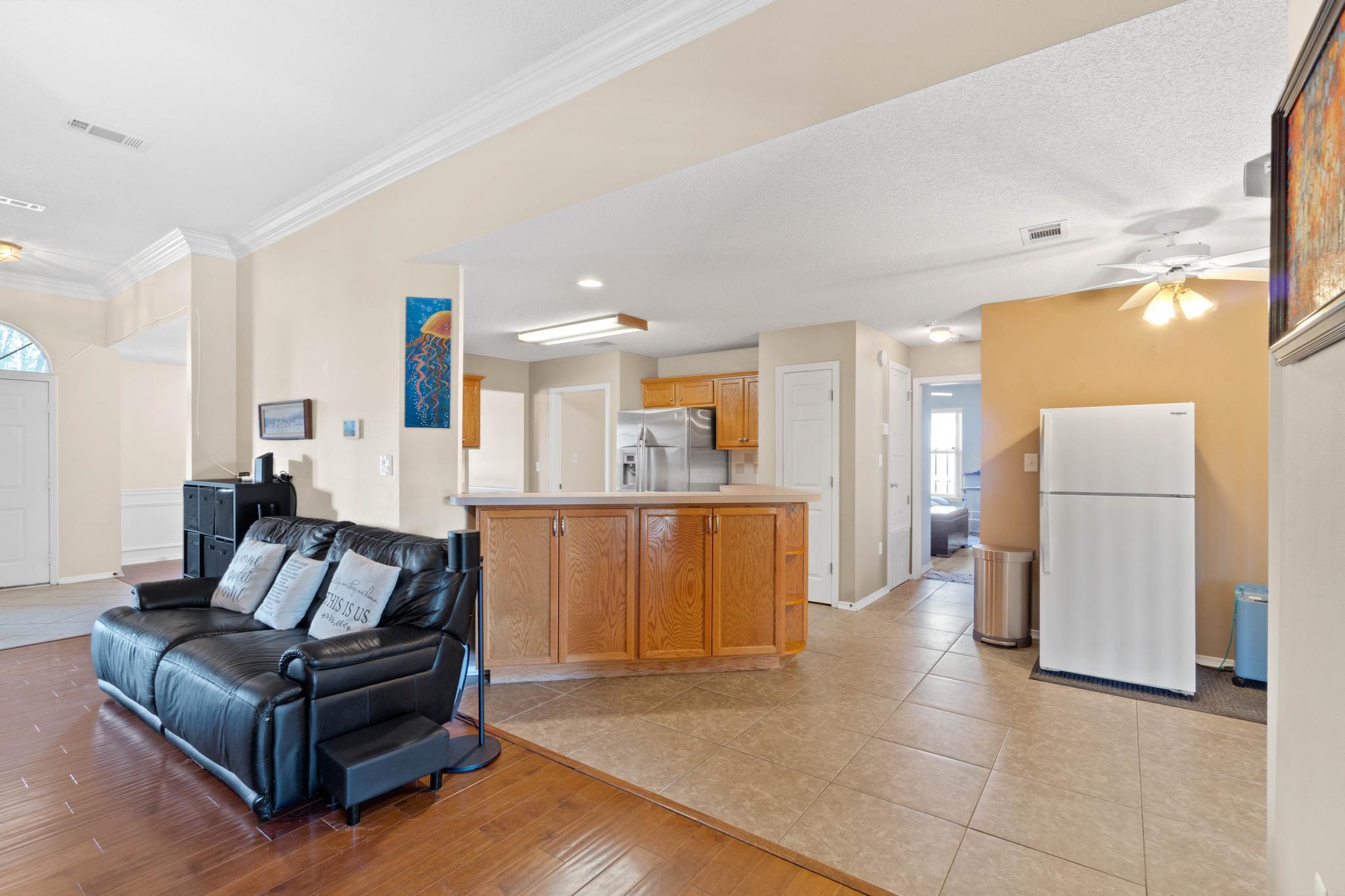 664 Brunson Street Crestview, FL 32536 - Photo 18 of 49 a living room with furniture and a refrigerator