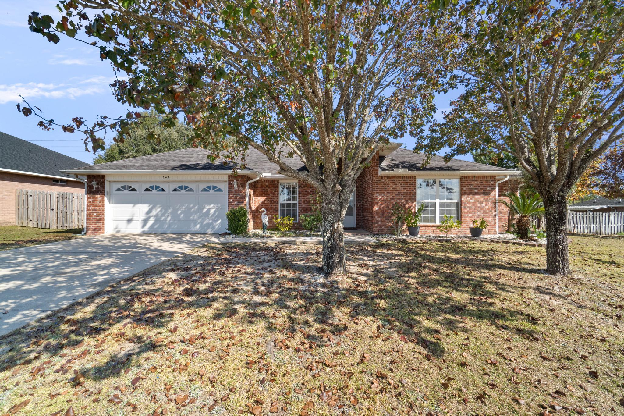 664 Brunson Street Crestview, FL 32536 - Photo 3 of 49 a front view of a house with a tree