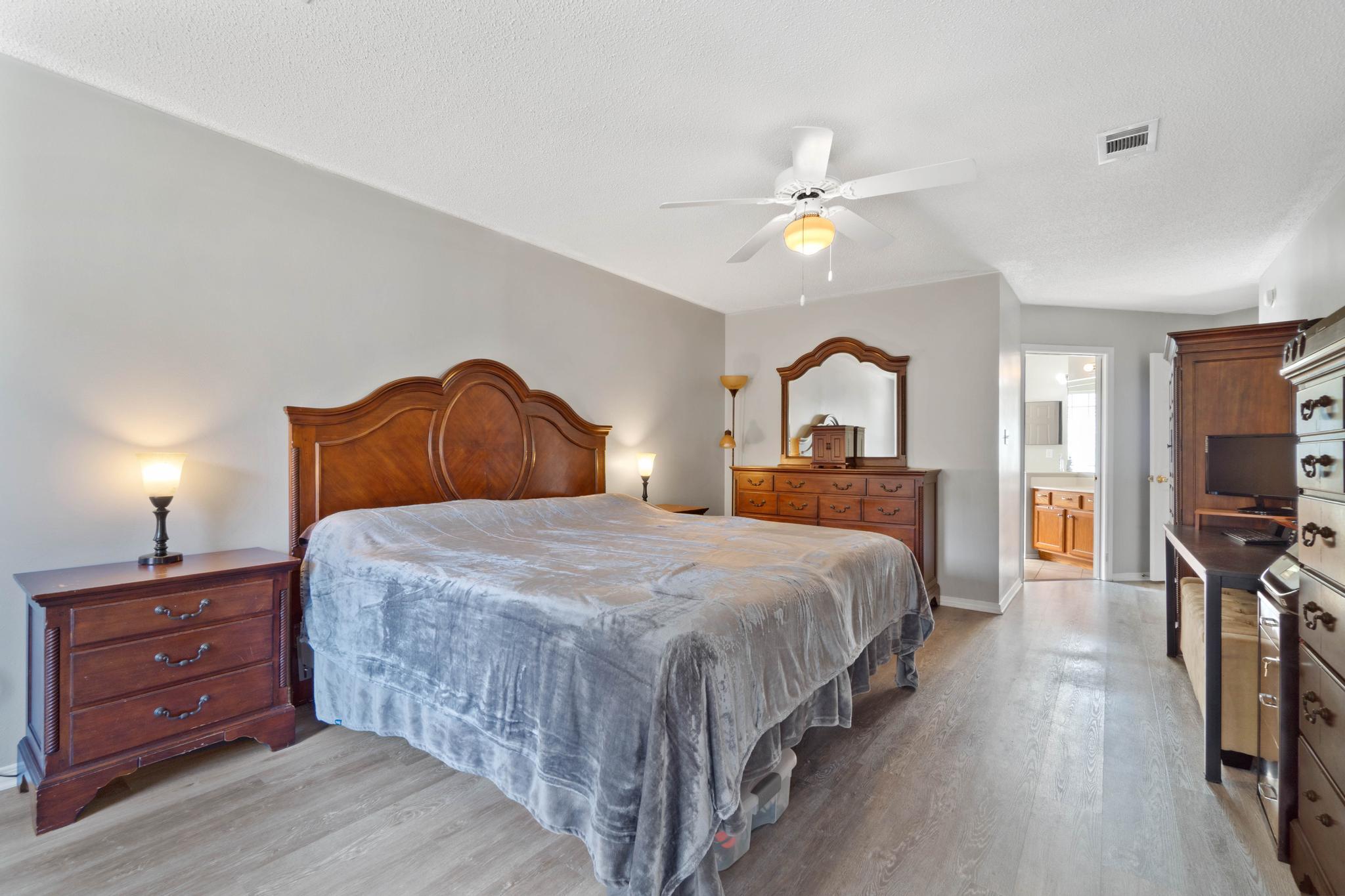 664 Brunson Street Crestview, FL 32536 - Photo 25 of 49 a bedroom with a bed and a chandelier