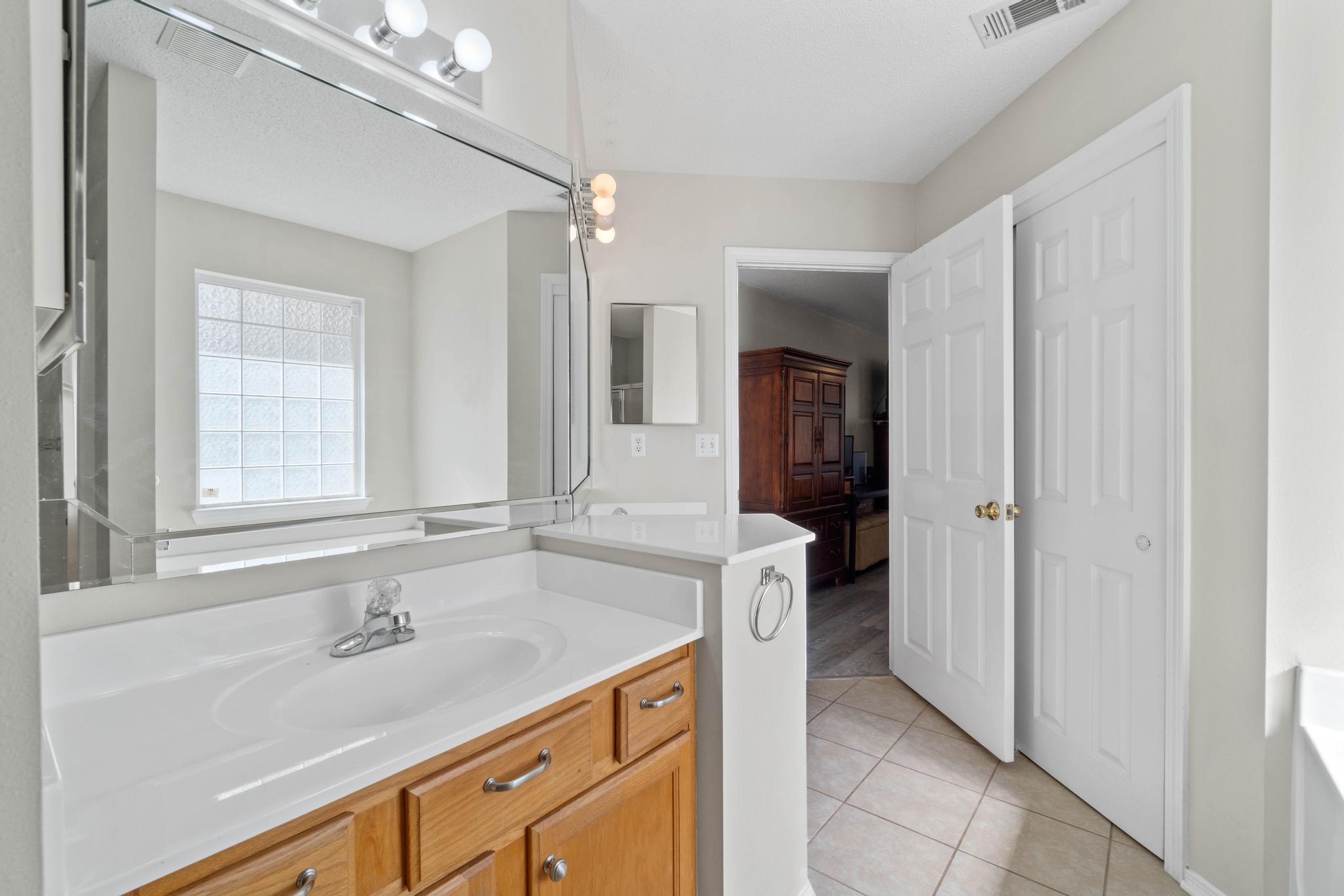 664 Brunson Street Crestview, FL 32536 - Photo 28 of 49 a bathroom with a sink and a mirror