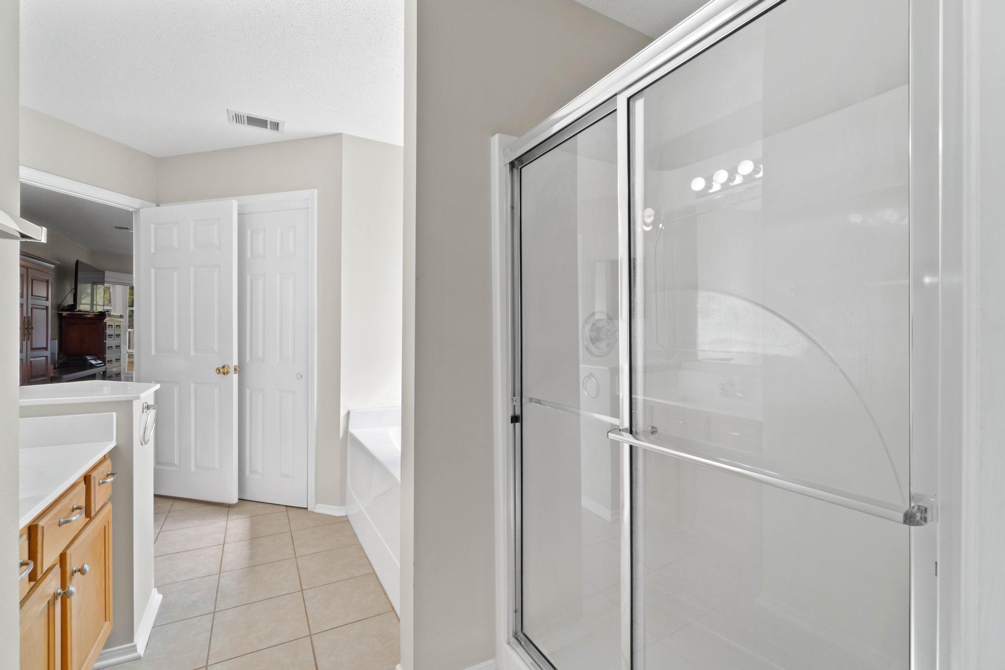 664 Brunson Street Crestview, FL 32536 - Photo 29 of 49 a bathroom with a shower and a glass door