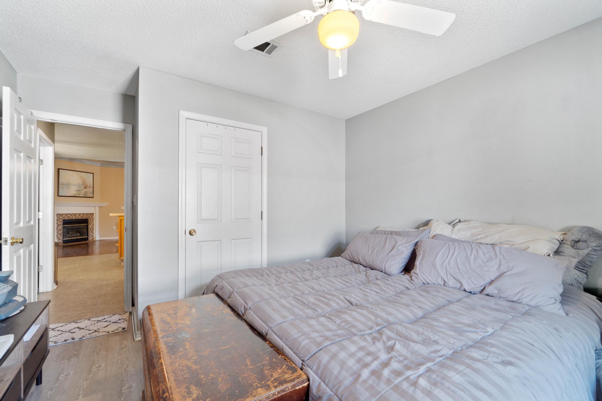 664 Brunson Street Crestview, FL 32536 - Photo 35 of 49 a bedroom with a bed and a chandelier