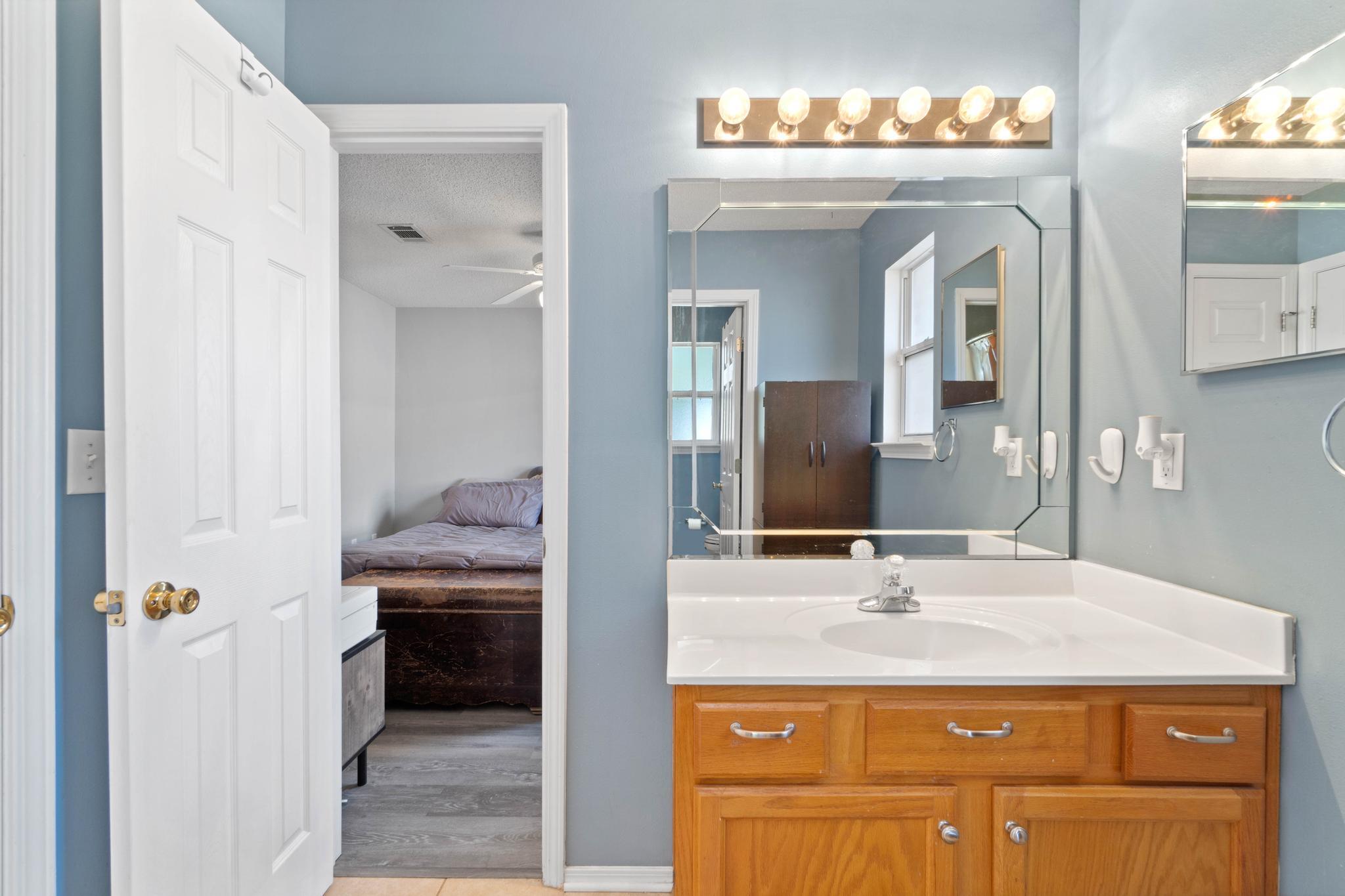 664 Brunson Street Crestview, FL 32536 - Photo 37 of 49 a bathroom with a sink and a mirror