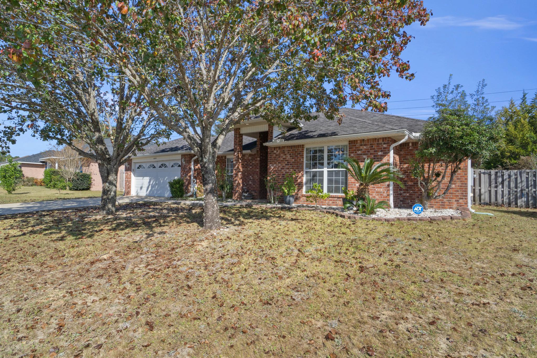 664 Brunson Street Crestview, FL 32536 - Photo 5 of 49 a view of a house with a yard