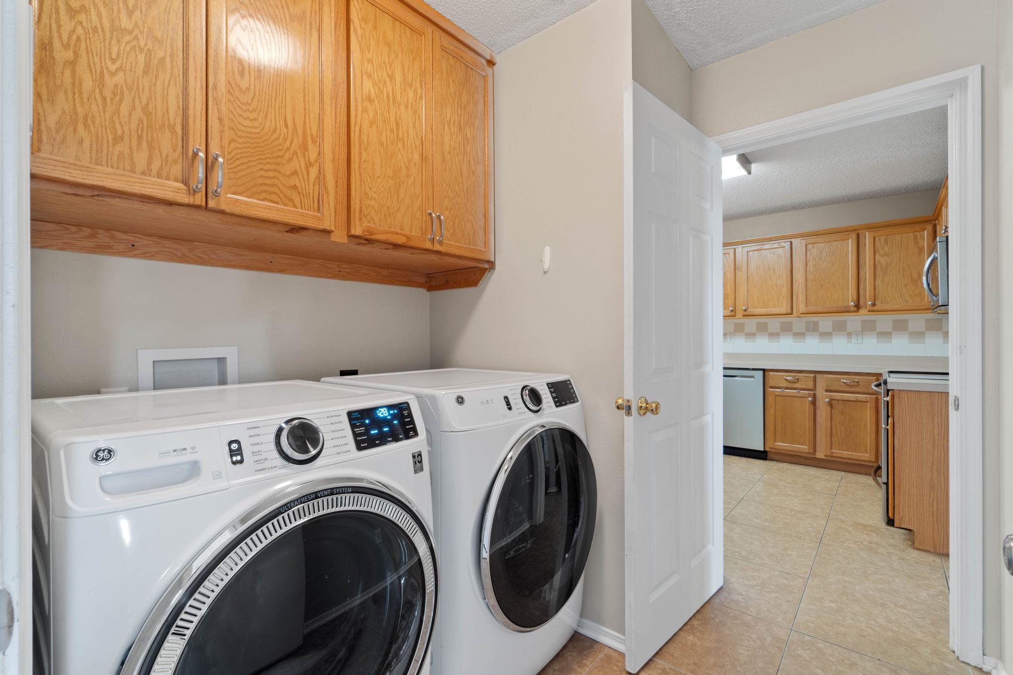 664 Brunson Street Crestview, FL 32536 - Photo 41 of 49 a view of washer and dryer with kitchen in the background
