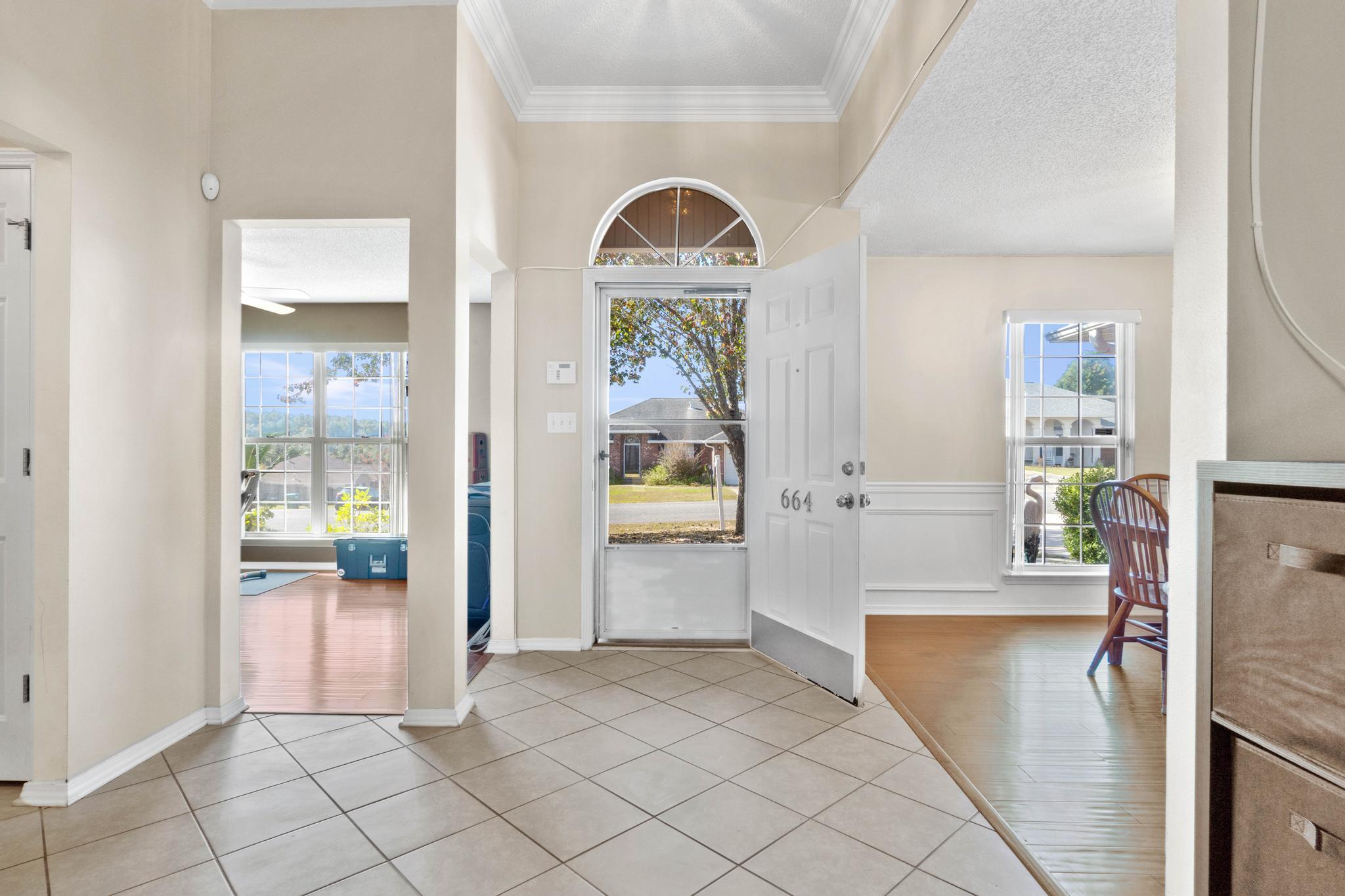 664 Brunson Street Crestview, FL 32536 - Photo 6 of 49 a view of a hallway view with wooden floor and a living room