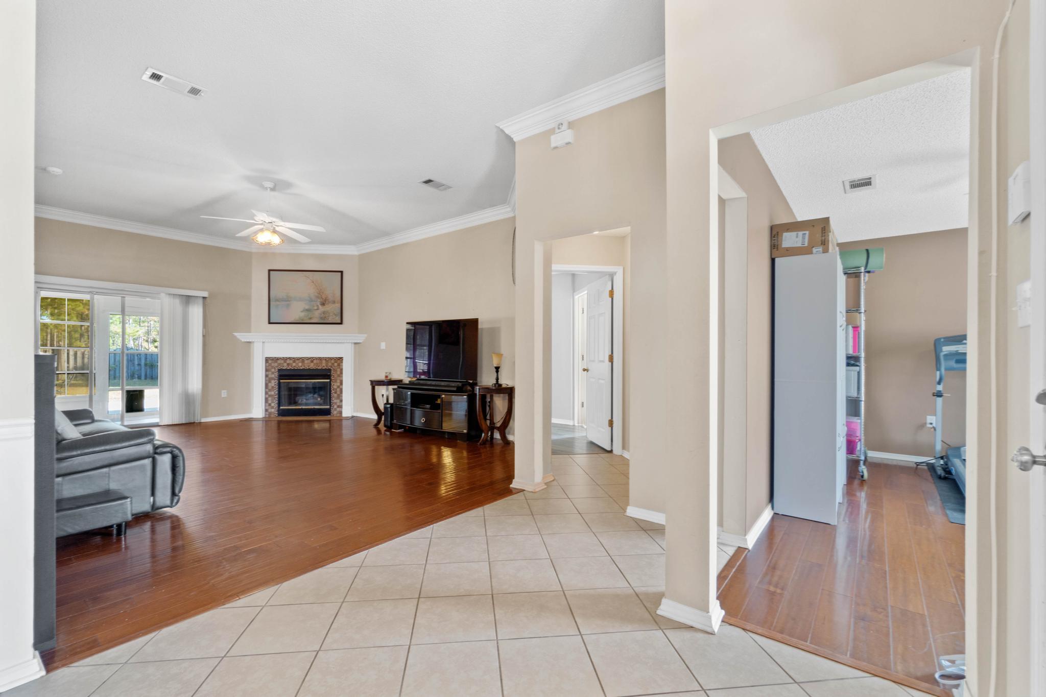 664 Brunson Street Crestview, FL 32536 - Photo 7 of 49 a living room with furniture and a flat screen tv