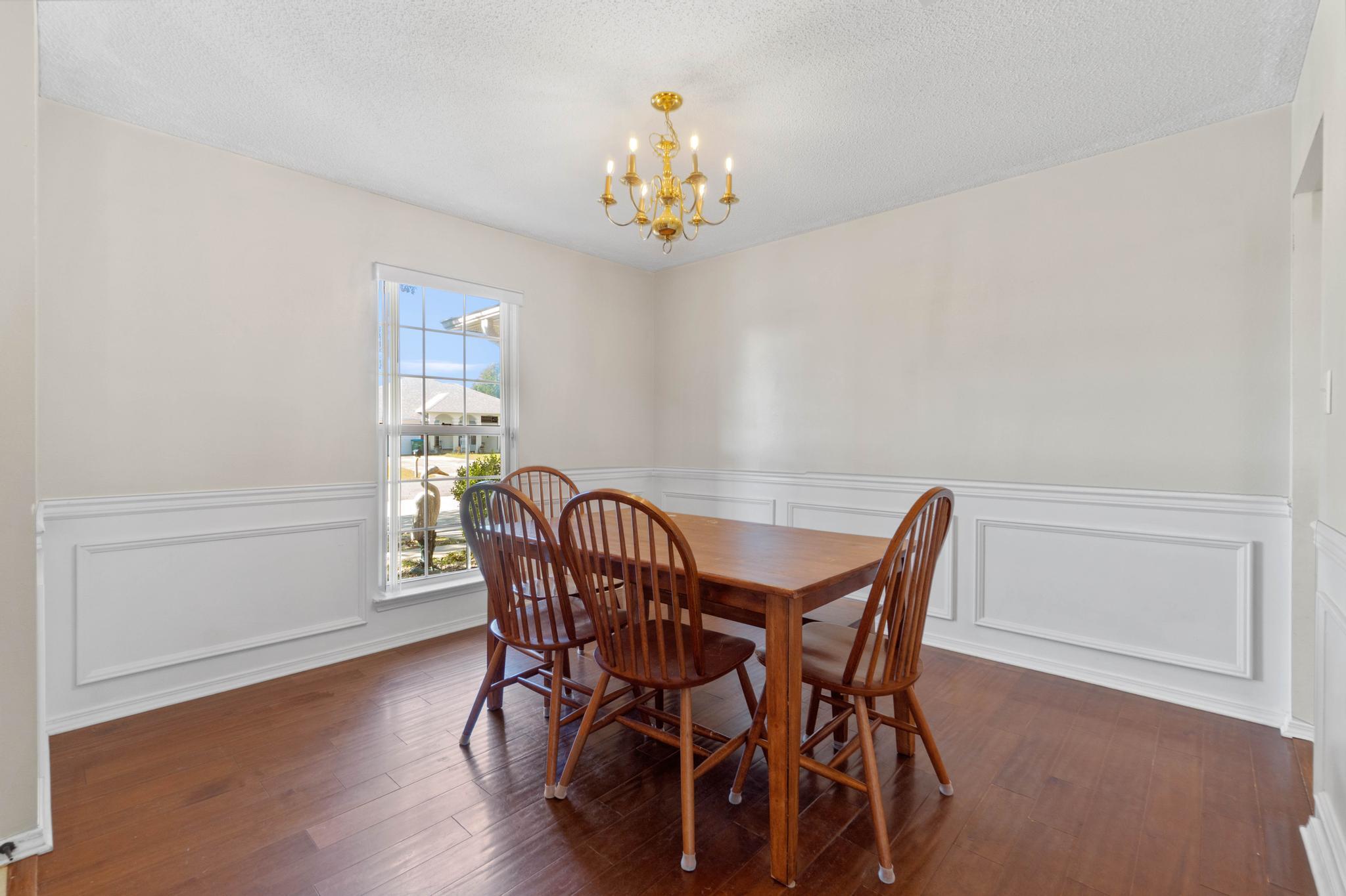 664 Brunson Street Crestview, FL 32536 - Photo 10 of 49 a view of a dining room with furniture and chandelier
