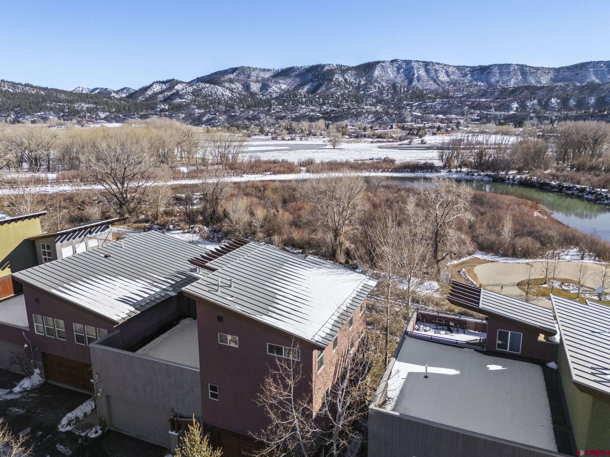 an aerial view of a house with a lake view