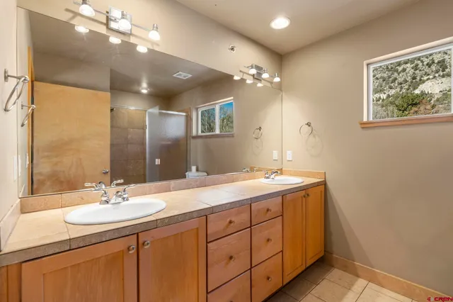 a bathroom with a sink double vanity and a mirror