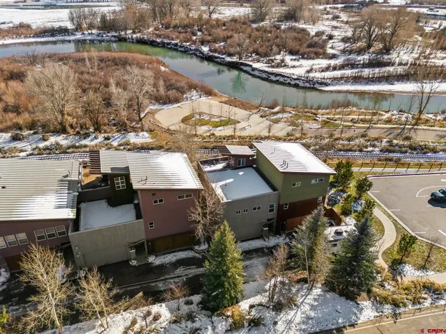 an aerial view of a house with a lake view