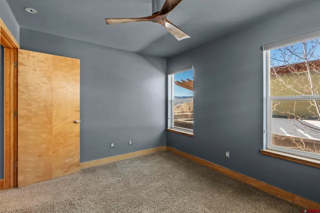 an empty room with windows and closet