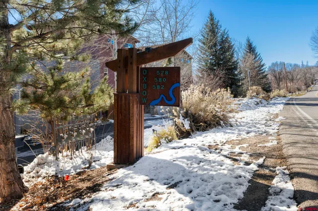 a view of a house with a yard covered in snow