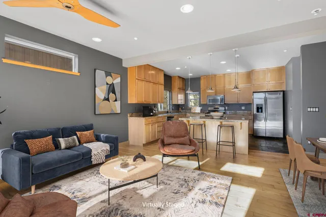 a living room with furniture and kitchen view