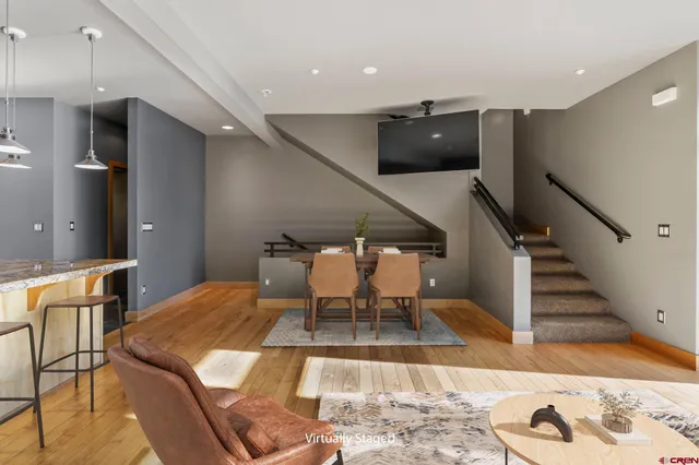 a dining room with furniture and wooden floor