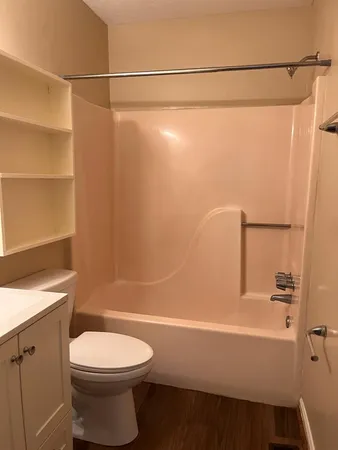 a bathroom with a toilet a sink and shower