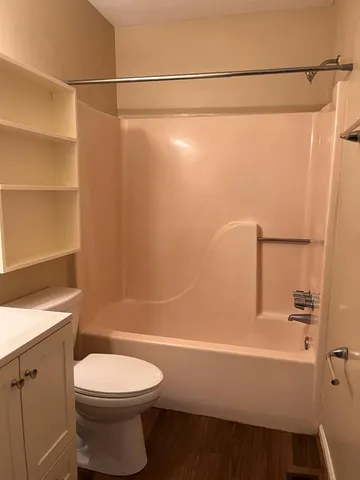 a bathroom with a toilet a sink and shower