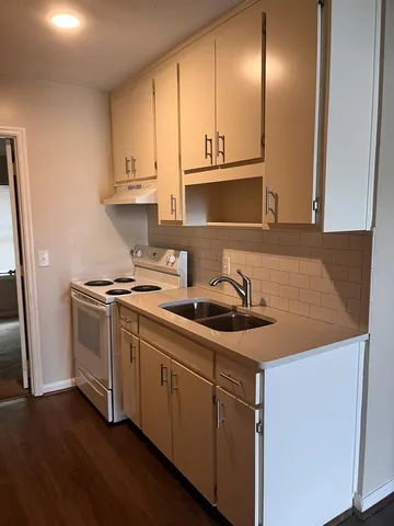 a kitchen with stainless steel appliances granite countertop a sink and a stove