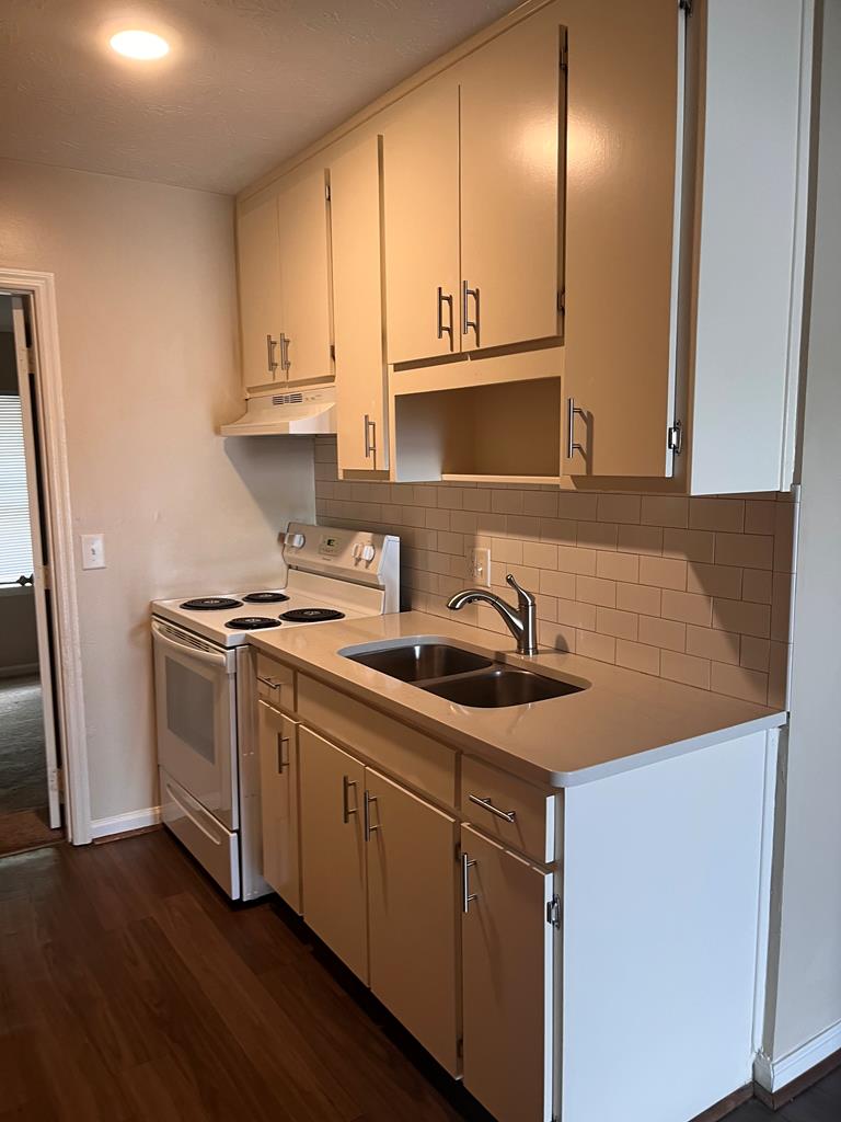1352 Rhodes Street, Unit B Columbus, GA 31901 - Photo 9 of 12 a kitchen with stainless steel appliances granite countertop a sink and a stove