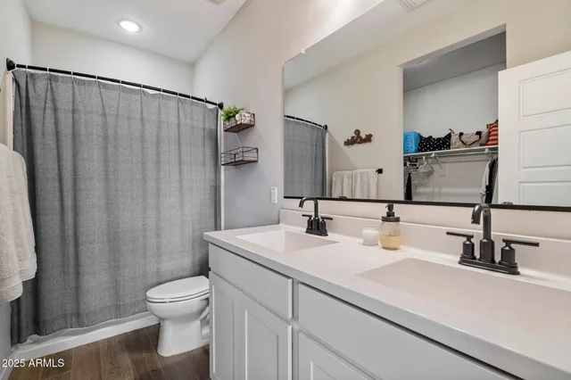 a bedroom with a large bed and a lamp on table