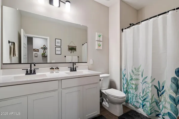 a bedroom with furniture and a large window