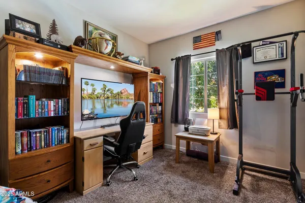 a bedroom with a bed and a lamp next to a window