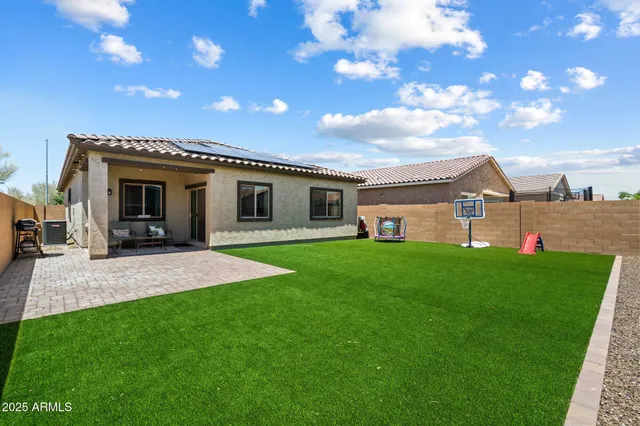 a view of a house with a yard porch and outdoor seating