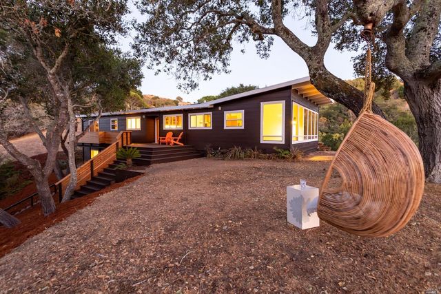 a view of a house with a chairs in a patio