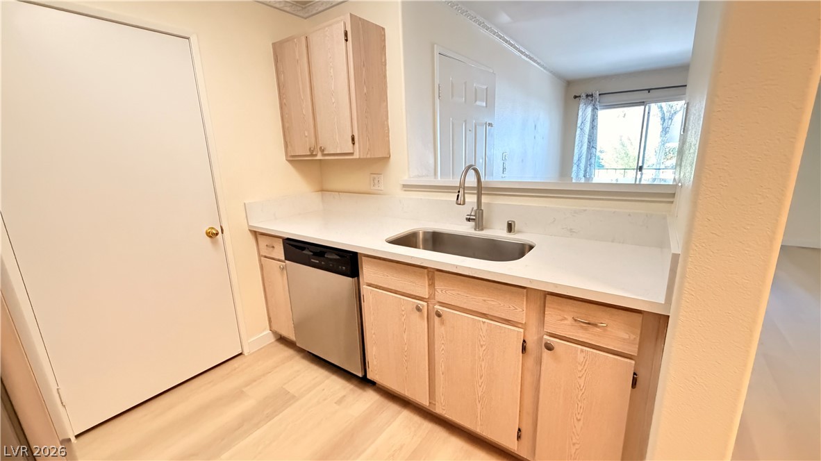 7885 West Flamingo Road, Unit 1131 Las Vegas, NV 89147 - Photo 18 of 36 A well-appointed kitchen featuring a stainless steel sink and a pass-through window to the living area.