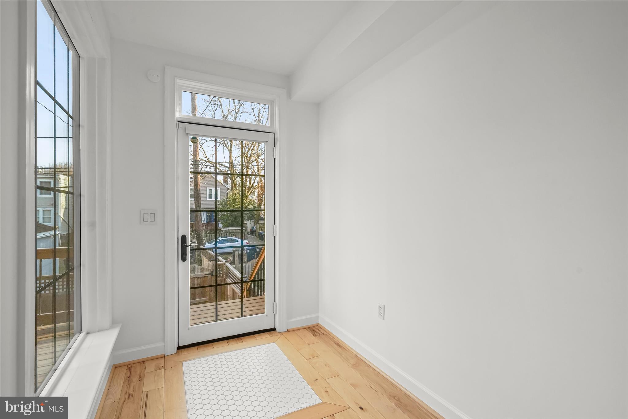 3626 T Street Northwest Washington, DC 20007 - Photo 14 of 61 a view of an empty room with wooden floor and a window