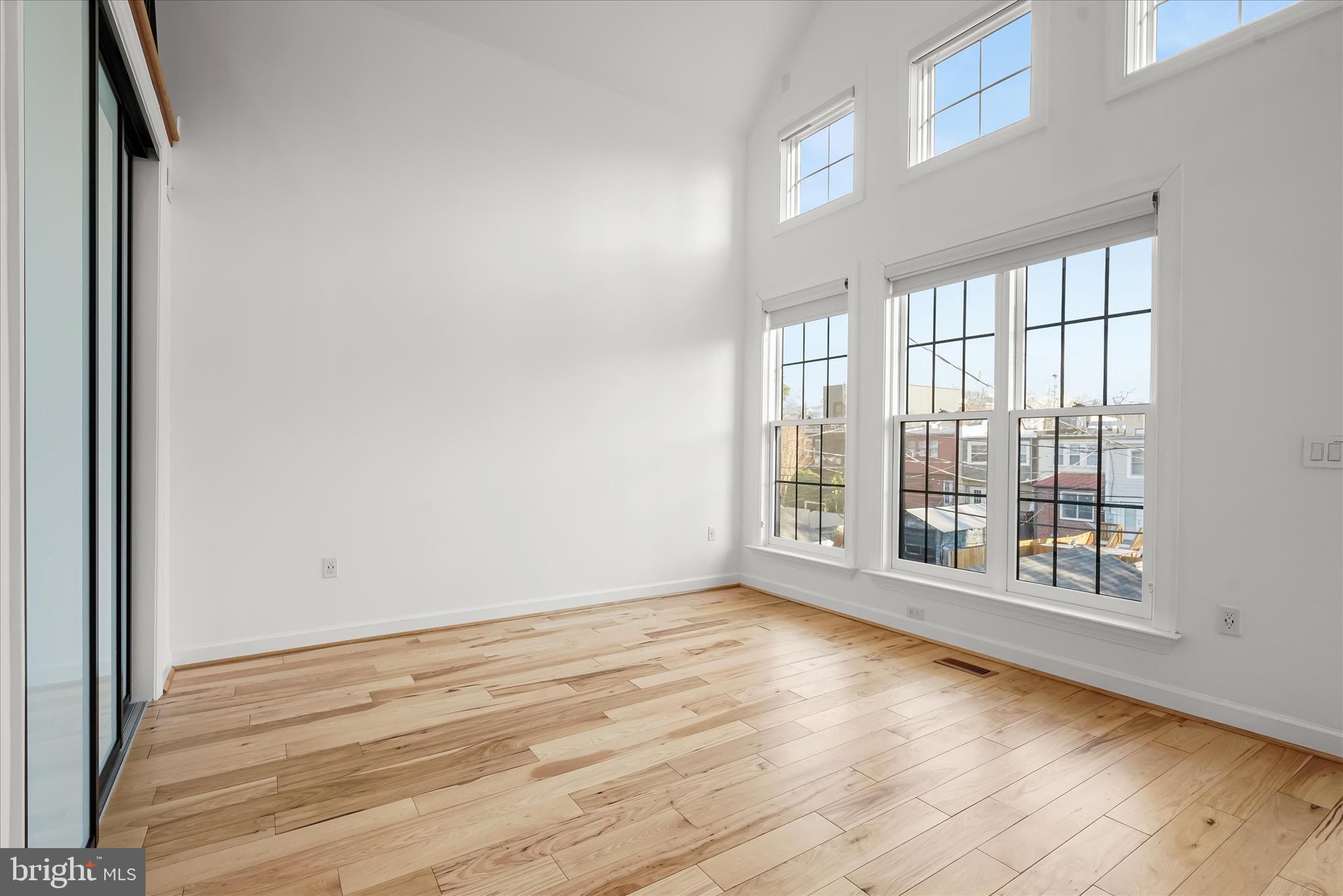 3626 T Street Northwest Washington, DC 20007 - Photo 17 of 61 a view of an empty room with wooden floor and a window