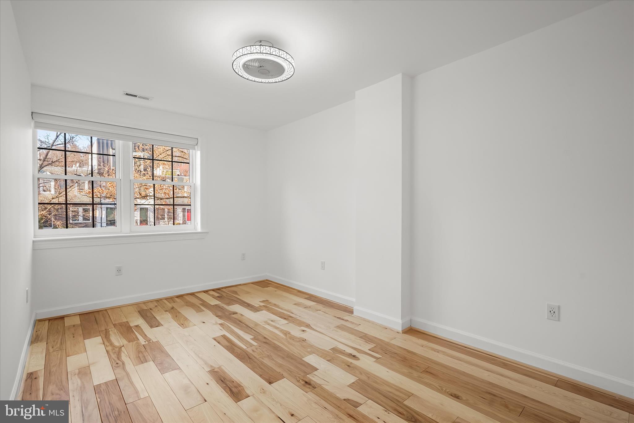 3626 T Street Northwest Washington, DC 20007 - Photo 27 of 61 a view of an empty room with wooden floor and a window