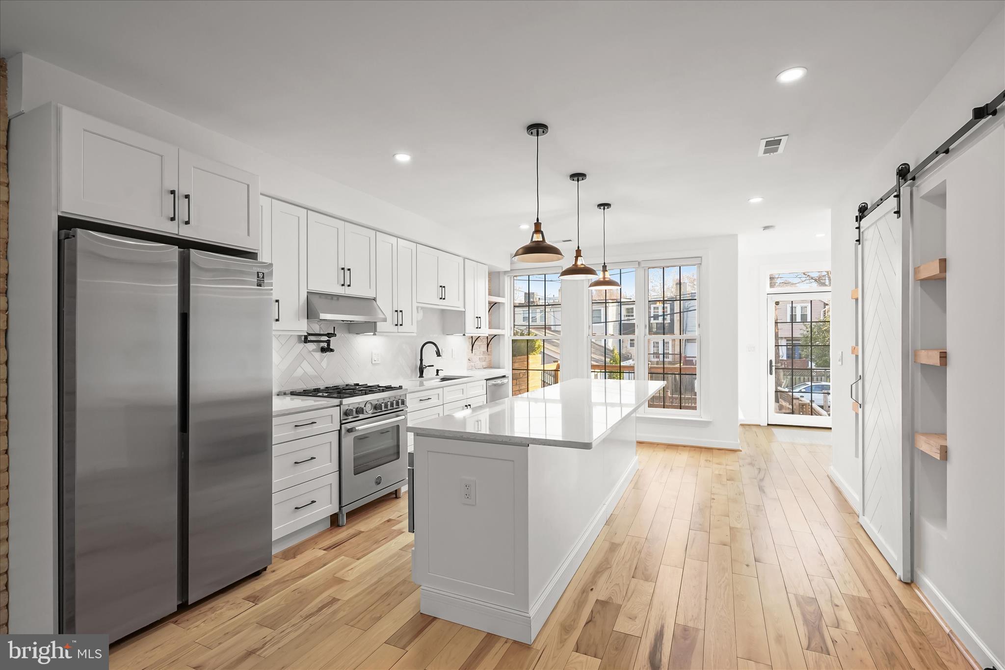 3626 T Street Northwest Washington, DC 20007 - Photo 3 of 61 a kitchen with stainless steel appliances a refrigerator a sink dishwasher a stove and white cabinets with wooden floor