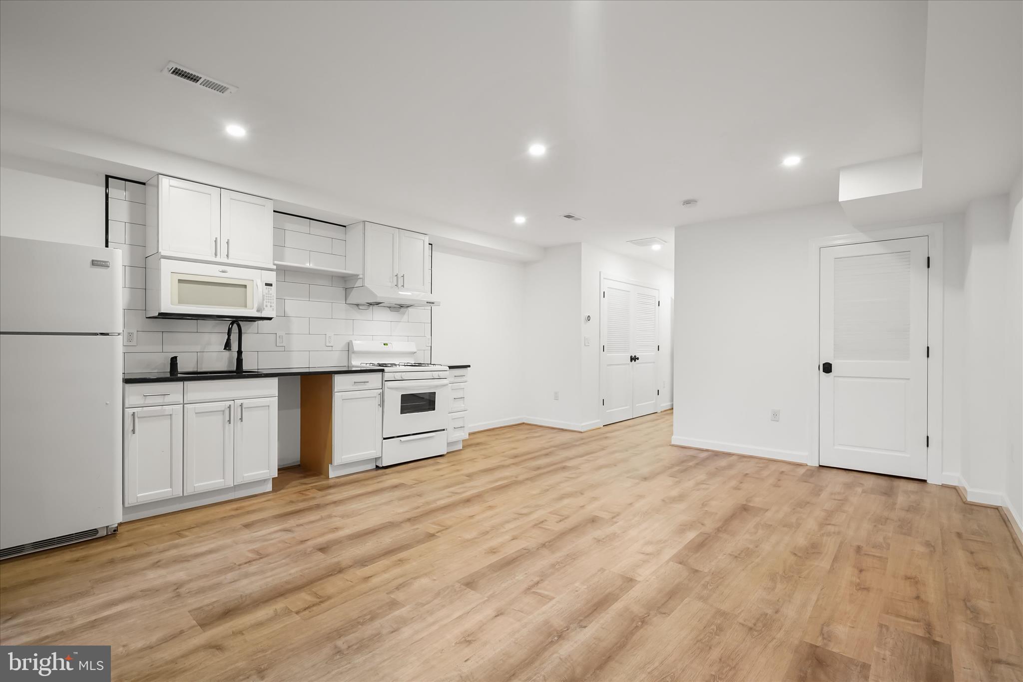 3626 T Street Northwest Washington, DC 20007 - Photo 36 of 61 a large kitchen with kitchen island a sink stainless steel appliances and cabinets
