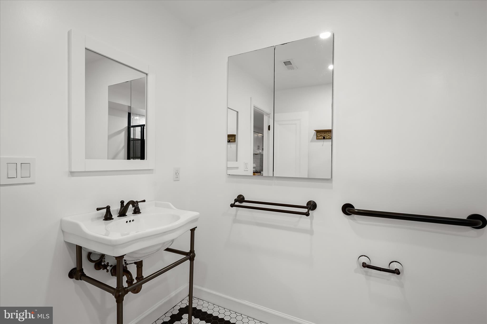 3626 T Street Northwest Washington, DC 20007 - Photo 43 of 61 a bathroom with a sink a mirror and a shower